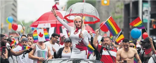  ?? RICHARD LAUTENS/TORONTO STAR ?? Hundreds of thousands came out to celebrate Toronto's Pride Parade. More than 120 groups took part in the event and people braved the rain to hit the street.