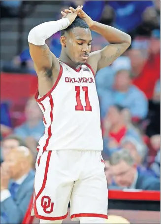  ?? [BRYAN TERRY/THE OKLAHOMAN] ?? Oklahoma's De-Vion Harmon walks toward the bench during the Sooners' loss to No. 6 Kansas on Tuesday night.