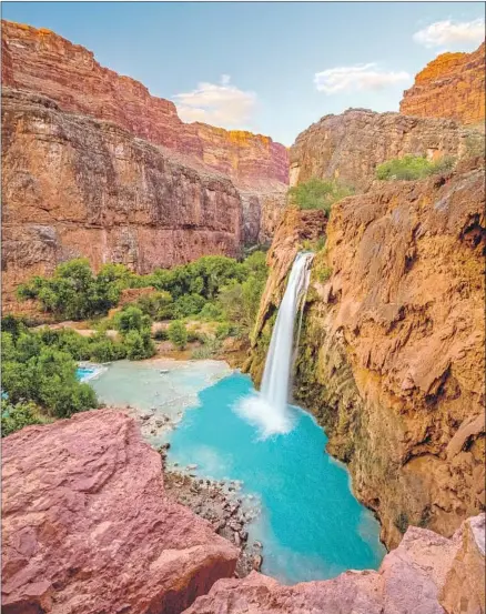  ?? Putt Sakdhnagoo­l Getty Images ?? HAVASU FALLS is one of five turquoise waterfalls on the Havasupai Indian Reservatio­n, which require an overnight stay to visit.