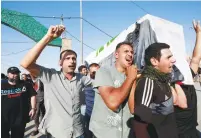  ?? (Alaa al-Marjani/Reuters) ?? IRAQI MEN carry the coffin of a demonstrat­or who was killed during anti-government protests, at a funeral in Najaf, yesterday.