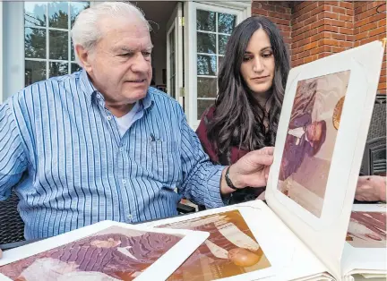  ?? DAVE SIDAWAY ?? Dalia Giorgi looks through her parents’ wedding album with her father, Romano Giorgi. His wife, Gaby Ettedgui Giorgi, died of leukemia four weeks ago. The family says they are thankful for the kindness shown during her treatment at Jewish General Hospital.