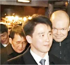  ??  ?? Choe (background left) leaves with other members of the North Korean delegation the restaurant Saaga in Central Helsinki, Finland. — AFP photo