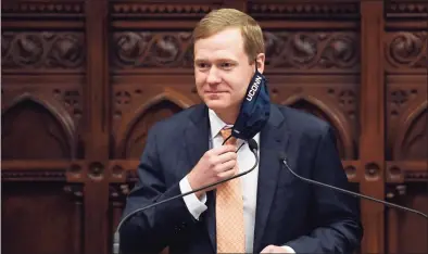  ?? Jessica Hill / Associated Press ?? Speaker of the House Matt Ritter, D-Hartford, pulls up his mask during a session at the Capitol on April 19.