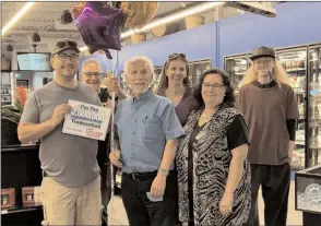  ??  ?? Reg Barber poses for a photo with Last Call Liquor Mart staff members Tim Turta, John Vassilaki, Stacey Isted, Barbara Vassilaki and Klint Clark after becoming the store’s 2-millionth customer.