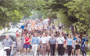  ?? CLIFF OWEN/AP ?? People walk to a church to say a prayer near the baseball field, the scene of the multiple shooting in Alexandria, Va.