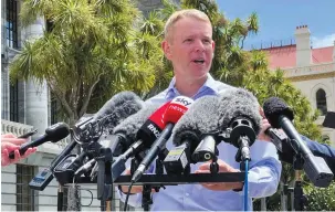  ?? (Lucy Craymer/Reuters) ?? CHRIS HIPKINS speaks to members of the media after being confirmed as the only nomination to replace Jacinda Ardern as leader of the Labour Party, outside New Zealand’s Parliament in Wellington yesterday.