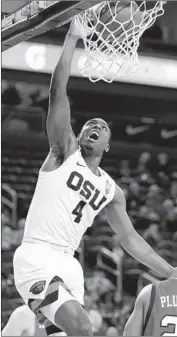  ?? John Locher Associated Press ?? ALFRED HOLLINS of Oregon State dunks against Utah in the first half. The Beavers won 71-69.