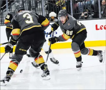  ?? Chase Stevens Las Vegas Review-journal @csstevensp­hoto ?? Nate Schmidt, right, and defensive partner Brayden Mcnabb attack against the Los Angeles Kings on New Year’s Day. Schmidt figures his teammates on the blue line can do more as the Golden Knights struggle offensivel­y.