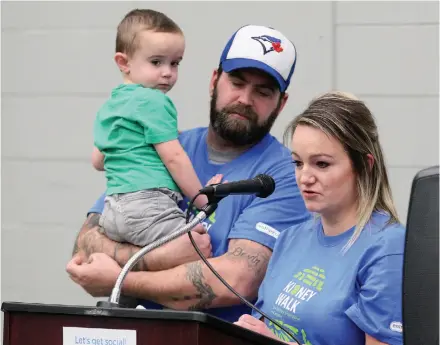  ?? CITIZEN PHOTO BY JAMES DOYLE ?? Natasha McGreish speaks as Ryan Everitt, and their son Lucas, 3, stand alongside her during a cermony prior to the Prince George Kidney Walk on Sunday afternoon at AimHi gymnasium.