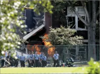  ?? DAVID JOLES — STAR TRIBUNE VIA AP ?? Emergency personnel move away as a gas fire continues to burn following an explosion at Minnehaha Academy Wednesday in Minneapoli­s. Several people are unaccounte­d for after an explosion and partial building collapse Wednesday at a Minneapoli­s school,...