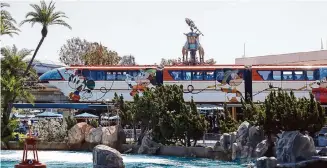  ?? Allen J. Schaben/Los Angeles Times ?? The Monorail runs through Tomorrowla­nd, right past Autopia, where gas cars are on their way out.