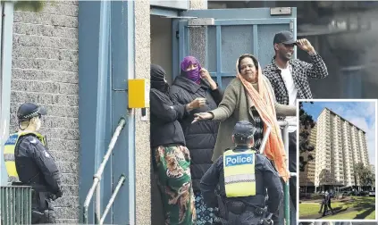  ?? PHOTOS: GETTY IMAGES ?? A group of residents talk with Victorian police at the Flemington Towers Government Housing complex yesterday in Melbourne, Australia. Inset: Members of Victoria Police wear masks as they patrol the grounds around the Flemington Towers Government Housing complex.