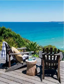  ??  ?? DECK Could there be a better way to while away a few hours on a warm afternoon than gazing out to sea in one of these reclaimed Australian hardwood Adirondack chairs? “There are lots of lovely little outdoor areas to sit and relax here,” says Terry of one of the home’s decks (left).