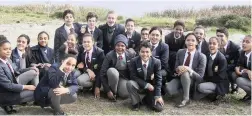  ??  ?? DIGGING FOR POSTERITY: Pupils from John Graham Primary School in Plumstead take a breather before planting indigenous plants on the banks of Princess Vlei that will provide food for birds and insects.