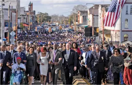  ?? AP PHOTO/MIKE STEWART ?? On Sunday, Vice President Kamala Harris and many others walk across the Edmund Pettus Bridge in Selma, Ala., commemorat­ing the 59th anniversar­y of the Bloody Sunday voting rights march in 1965.