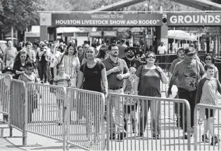  ?? Jon Shapley / Staff file photo ?? People leave the Houston Livestock Show and Rodeo after its cancellati­on was announced due to concerns about COVID-19 on Wednesday. Officials have tied two more cases to the rodeo cookoff.