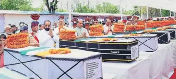  ?? PTI PHOTO ?? Union home minister Rajnath Singh pays tribute to the slain CRPF jawans on Tuesday in Raipur.