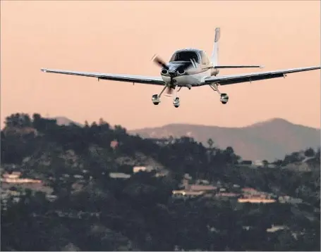  ?? Francine Orr Los Angeles Times ?? A PLANE lands at Santa Monica Airport. The Federal Aviation Administra­tion has threatened legal action against the city over its effort to reduce f light operations at the airport, force out aeronautic­al tenants and close the historic facility within...