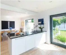  ??  ?? The open-plan kitchen and dining room is at the back and has glass doors to the garden