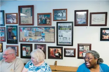  ?? MORNING CALL PHOTOS JOSEPH SCHELLER/THE ?? John and Brenda Sweeney, left, laugh with a restaurant host while waiting to be seated Friday at the Brass Rail in Allentown on its next-to-last business day. The restaurant and bar was open at its Lehigh Street location for 91 years.