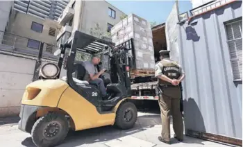  ??  ?? ► Cajas con la PSU en su interior son trasladada­s desde el Demre hacia locales.