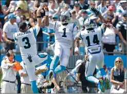  ??  ?? Carolina Panthers’ Cam Newton (1) celebrates his touchdown pass with Derek Anderson (3) and Joe Webb (14).