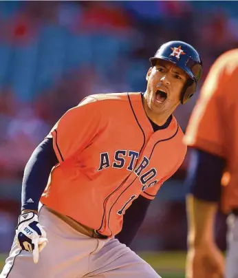  ?? Mark J. Terril / AP Photo ?? Rounding first base against the Angels on Sunday, Carlos Correa celebrates after hitting the Astros’ first pinch-hit homer in extra innings in more than 15 years.