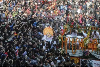  ??  ?? Party workers place the body of late former Nepalese Prime Minister and Nepali Congress Party president Sushil Koirala on a funeral truck in Kathmandu on Wednesday. —