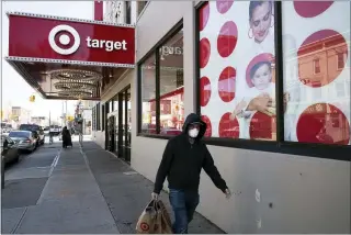  ?? MARK LENNIHAN — THE ASSOCIATED PRESS FILE ?? A customer leaves a Target store in Brooklyn, N.Y. s part of its racial equity program, the Minneapoli­sbased discounter will add products from more than 500Black-owned businesses across all types of merchandis­ing areas.