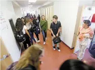  ?? LUIS SÁNCHEZ SATURNO THE NEW MEXICAN ?? LEFT: Spanish teacher Maritza Sanchez watches students in the hallway at the end of the school day Tuesday. The school saw a jump from a D to a B over the past year, in part because its highestper­forming students made achievemen­t gains.