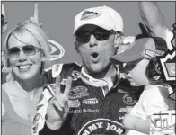  ?? AP/RICK SCUTERI ?? Kevin Harvick is joined by his wife DeLana (left) and son Keelan, after winning the CampingWor­ld.com 300 at Phoenix Internatio­nal Raceway. Harvick won by 1.153 seconds over Jamie McMurray.