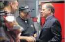  ?? GETTY IMAGES ?? Democratic senatorial candidate Doug Jones (right) greets owner Chris Zarzaur during a campaign stop at Chris Z’s restaurant in Birmingham.