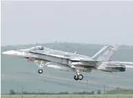  ?? MIRCEA ROSCA / AFP / GETTY IMAGES ?? A CF-18 fighter jet taking off.