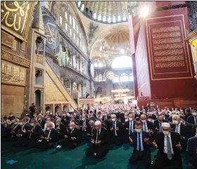  ?? (AP/Turkish Presidency) ?? Turkish President Recep Tayyip Erdogan (center) on Friday takes part in the first Muslim prayers in 86 years at the historic Hagia Sophia in Istanbul. More photos are available at arkansason­line.com/725turkey/