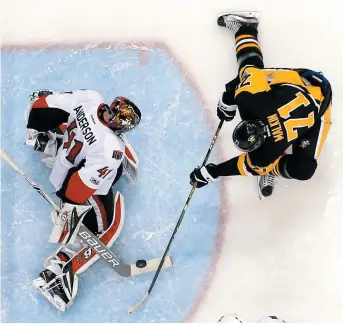  ??  ?? Le gardien des Sénateurs d’Ottawa, Craig Anderson, freine le dangereux Evgeni Malkin, des Penguins de Pittsburgh, samedi. - Associated Press: Gene J. Puskar