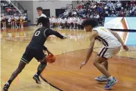  ?? The Sentinel-record/donald Cross ?? Hot Springs’ Nasir Hannah (0) attempts to dribble past Lake Hamilton’s Labraun Christon (1) Friday at Wolf Arena.