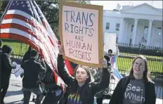  ??  ?? Activists from the National Center for Transgende­r Equality, partner organizati­ons and their supporters attend a “We Will Not Be Erased” rally Monday in front of the White House.