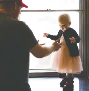  ?? CHRISTINNE MUSCHI / NATIONAL POST ?? Lyana Deslaurier­s, 2, with dad Joel at Sainte-Justine children’s hospital in Montreal.