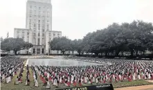  ?? Dug Begley / Staff ?? Flags represente­d the people who died on Texas roads last year and marked 19 years since the last day without a road fatality.