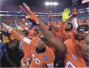  ?? BOB DONNAN, USA TODAY SPORTS ?? Clemson players celebrate Dec. 5 after beating North Carolina 45-37 for the Atlantic Coast Conference title and a spot in the College Football Playoff.