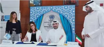  ?? —Photo by Joseph Shagra ?? KUWAIT: Head of the UNHCR office in Kuwait Dr Hanan Hamdan and Omar Al-Ghanim, CEO of AlGhanim Industries, sign the memorandum of understand­ing.