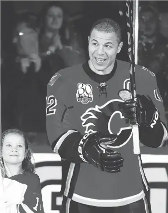  ?? LYLE ASPINALL PHOTO ?? Jarome Iginla of the Calgary Flames acknowledg­es the cheers of the crowd while posing with his Team Canada Olympic gold medal before a game in March of 2010. Iginla assisted on Sidney Crosby’s overtime golden goal against the U.S. in the Olympic final...