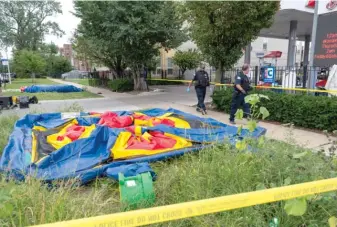  ??  ?? Chicago police walk near a deflated bounce-house while investigat­ing a shooting Saturday in which three people were wounded, including Ayonna Fleming Peterson (below) and her 11-year-old step-brother.