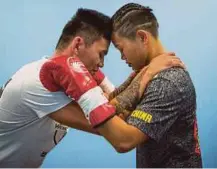  ??  ?? Huang Wensi’s assistant coach saying a few motivation­al words before a match in
Taipei last year. He said: ‘Don't think about winning or losing, fight for honour. Think about your family.’