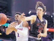  ?? CHARLIE REIDEL/ASSOCIATED PRESS ?? New Mexico State’s Ivan Aurrecoech­ea, right, knocks the ball away from Kansas’ Dedric Lawson (1) during the first half. NMSU played the No. 2 Jayhawks even but fell 63-60.