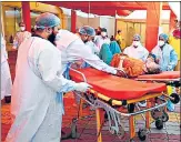  ?? RAJ K RAJ/HT PHOTO ?? Health workers transfer a Covid-19 patient from Sri Guru Teg Bahadur Covid-19 care centre to Lok Nayak Hospital in Delhi on Tuesday.