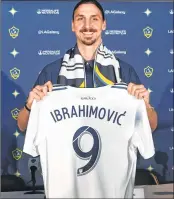  ??  ?? Zlatan Ibrahimovi­c holds up his new team jersey at his first press conference for his new club LA Galaxy in Los Angeles, California.