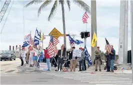  ?? ANTHONY MAN/STAFF ?? On the other side of the Lake Worth Lagoon, the president’s supporters waved American flags and Trump “Make America Great Again” flags.