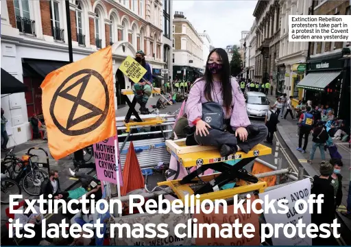  ??  ?? Extinction Rebellion protesters take part in a protest in the Covent Garden area yesterday