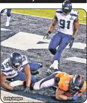  ?? Getty Images ?? Seattle’s Cliff Avril falls on Denver running
back Knowshon Moreno for a safety.